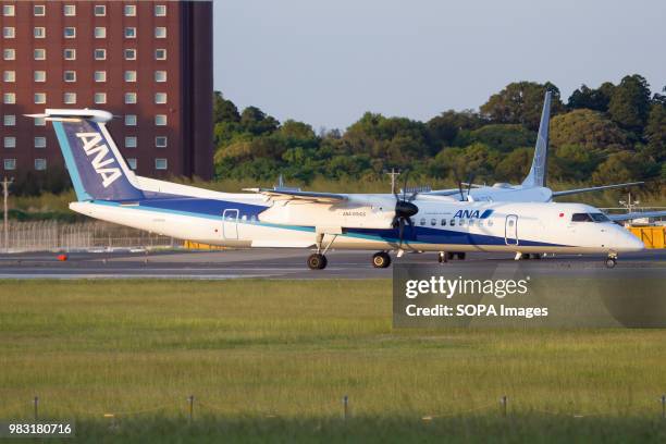 All Nippon Airways ANA Wings Bombardier Dash 8-400 lining up at Tokyo Narita airport,.