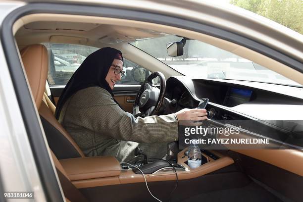 Saudi national and newly licensed Reem Farahat, an employee of Careem, a chauffeur car booking service, prepares for a customer shuttle using her car...