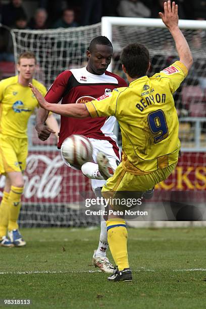 Abdul Osman of Northampton Town contests the ball with Elliot Benyon of Torquay United during the Coca Cola League Two Match between Northampton Town...