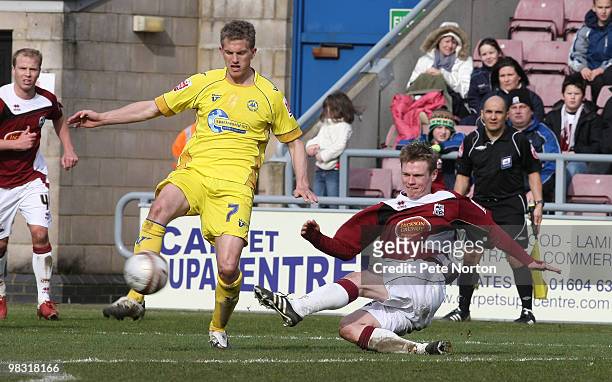 Billy McKay of Northampton Town gets in a shot at goal past Lee Mansell of Torquay United during the Coca Cola League Two Match between Northampton...