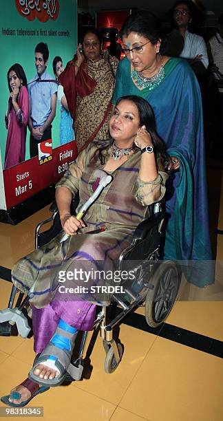 Indian actress Shabana Azmi is pushed in a wheelchair by Aparna Sen as they attend the premiere of Hindi film �The Japanese Wife� in Mumbai late...