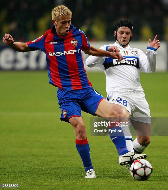 Keisuke Honda of CSKA Moscow battles for the ball with Cristian Chivu of FC Internazionale Milano during the UEFA Champions League Quarter Finals,...