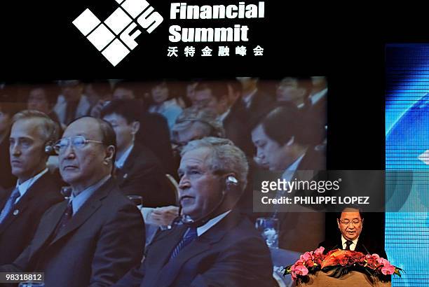 Former US president George W. Bush is seen on a video screen as China's Secretary of the Political Bureau of the Central Committee of the CPC and...