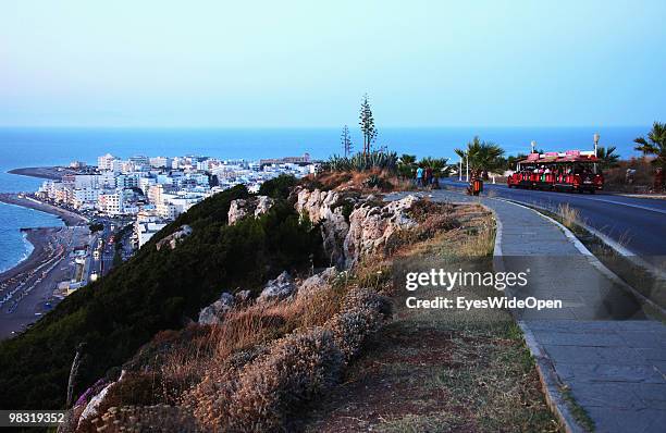 The city of rhodes and a sightseeing train with tourists on July 16, 2009 in Rhodes, Greece. Rhodes is the largest of the Greek Dodecanes Islands.