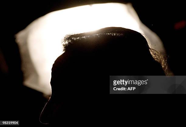 The top of Britain's Conservative Party leader David Cameron's head is shown against a studio light as he speaks to an audience of supporters at a...