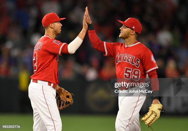 Andrelton Simmons and Michael Hermosillo of the Los Angeles Angels of Anaheim celebrate a 2-1 win over the Toronto Blue Jays at Angel Stadium on June...