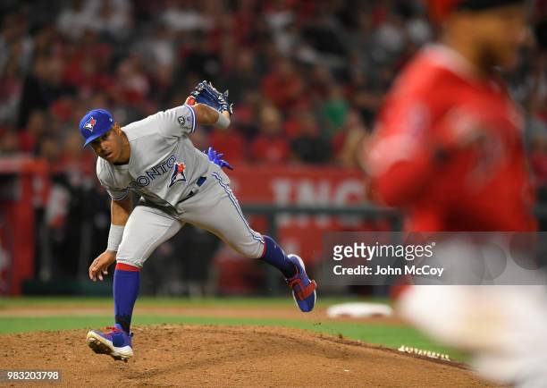 Yangervis Solarte of the Toronto Blue Jays made a throw to catch Michael Hermosillo of the Los Angeles Angels of Anaheim at first in the at Angel...