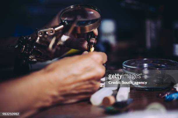 woman making jewelry in store - jasper mineral stock pictures, royalty-free photos & images