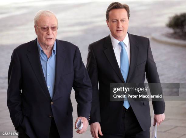 Conservative party leader David Cameron walks with actor Sir Michael Caine as he launches a 'National Citizens Service' on April 8, 2010 in London,...