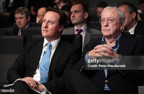 Conservative party leader David Cameron sits with actor Sir Michael Caine as he launches a 'National Citizens Service' on April 8, 2010 in London,...