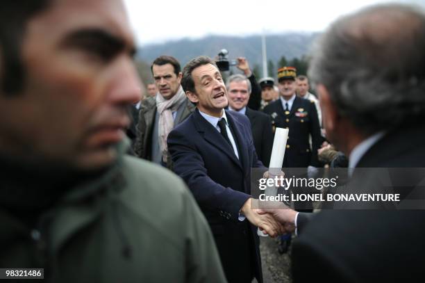 French president Nicolas Sarkozy salutes people as he attends a ceremony to pay tribute to World War II resistance fighters, on April 8, 2010 at the...