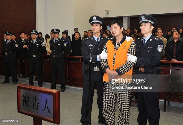 Zheng Minsheng, center, stands trial on April 8, 2010 in Nanping in southeast China's Fujian province. Minsheng who stabbed eight children to death...