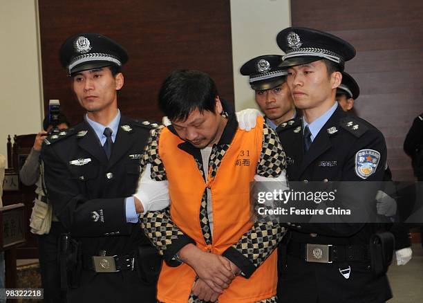Zheng Minsheng, center, leaves the court on April 8, 2010 in Nanping in southeast China's Fujian province. Minsheng who stabbed eight children to...