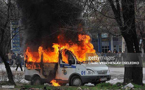 Police vehicle burns vehicle during an anti-government protest in Bishkek on April 7, 2010. Opposition followers killed Kyrgyzstan's interior...
