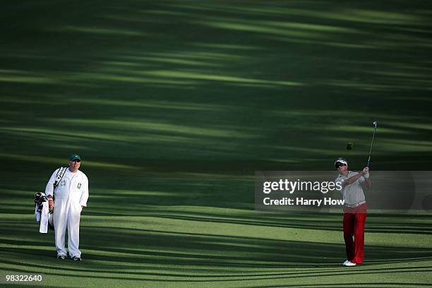 Brian Gay hits a shot on the second hole as his caddie Kip Henley looks on during the first round of the 2010 Masters Tournament at Augusta National...