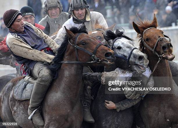 Mounted Kyrgyz men perform a traditional central Asian sport 'Kok-Boru ' in Bishkek on March 21, 2010 during the annual Nowruz celebrations, to mark...