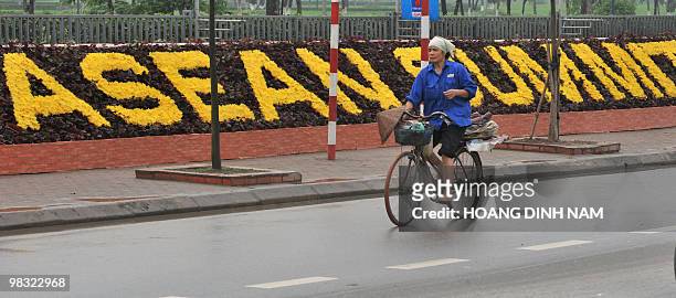 Cyclist rides past the My Dinh National Convention Center, the main venue for the up-comming 16th summit of the Southeast Asian Nations in Hanoi on...