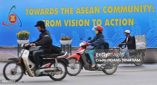Motorcyclists ride past the My Dinh National Convention Center, the main venue for the up-comming 16th summit of the Southeast Asian Nations in Hanoi...