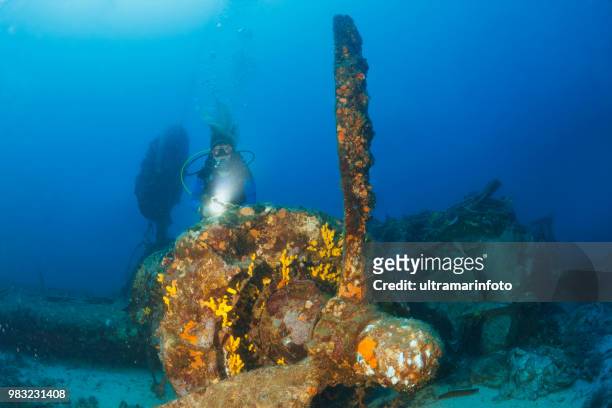 scuba diving exploring and enjoying wreck diving over a b-24 liberator bomber wreck sea life  sporting women long blonde hair  water sports  scuba diver point of view.  vis, adriatic sea, croatia. - b 24 liberator stock pictures, royalty-free photos & images