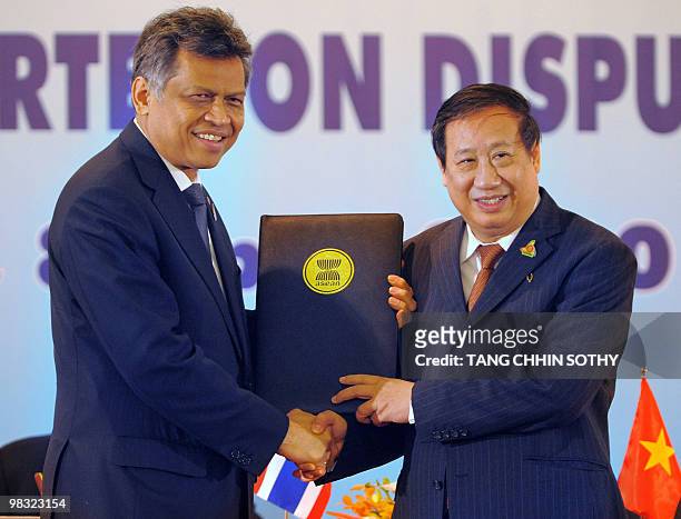 The ASEAN Summit of the Southeast Asian Nations Secretary-General Surin Pitsuwan of Thailand , shakes hands with Vietnam's Foreign Minister Pham Gia...