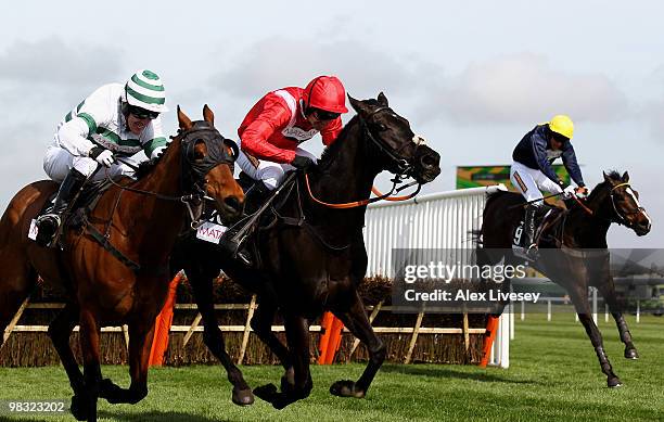 Barizan ridden by A.P McCoy and Sanctuaire ridden by Ruby Walsh land over the last fence ahead of eventual winner Orsippus ridden by D.J Condon in...