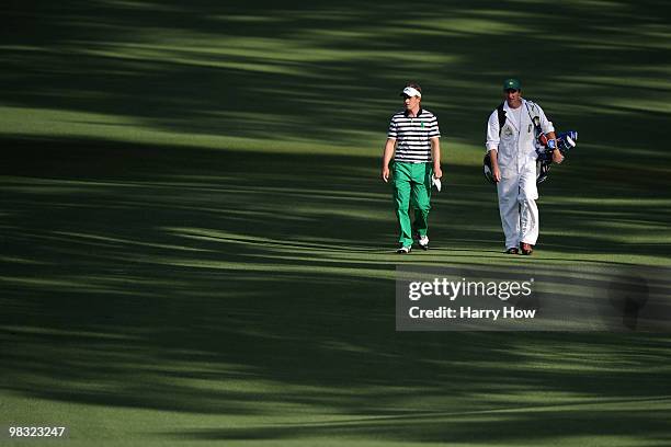 Luke Donald of England walks with his caddie John McLaren on the second hole during the first round of the 2010 Masters Tournament at Augusta...