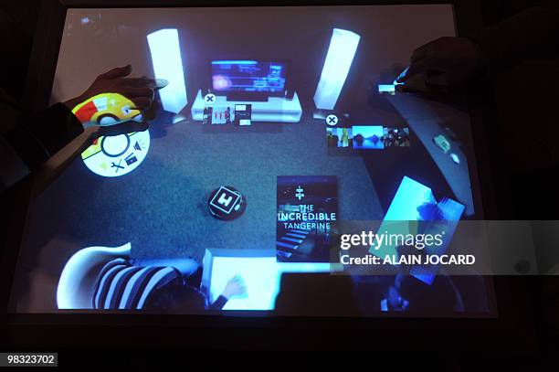 People use a table Cristal on April 7, 2010 in Laval, during the 12th edition of the Laval Virtual show dedicated to virtual technology. The Cristal...