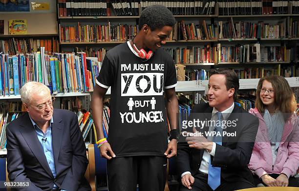 British actor Sir Michael Caine and British Opposition Conservative Party leader David Cameron look on as student Daryl Brown shows off his printed...