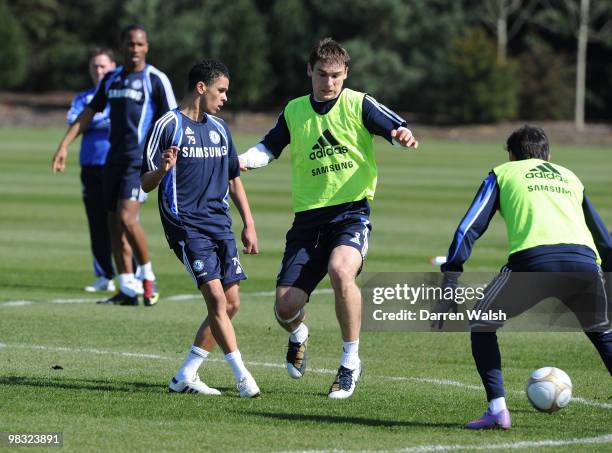 Billy Clifford and Branislav Ivanovic of Chelsea in action during a training session at the Cobham training ground on April 8, 2010 in Cobham,...