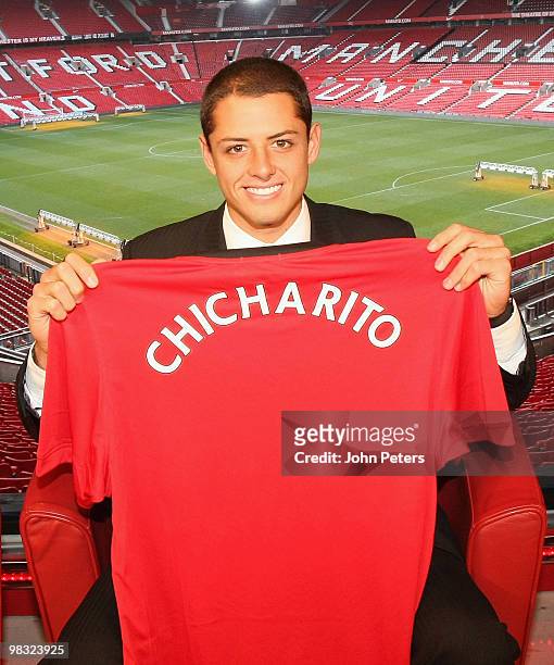 Javier Hernandez poses with a Manchester United shirt with his nickname Chicharito on the back, at Old Trafford on April 8 2010 in Manchester,...