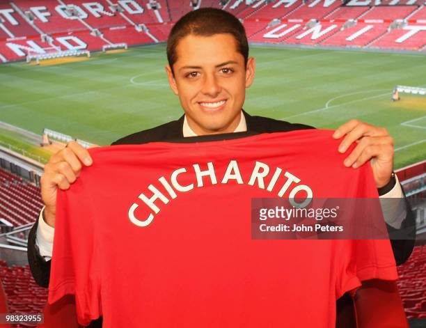 Javier Hernandez poses with a Manchester United shirt with his nickname Chicharito on the back, at Old Trafford on April 8 2010 in Manchester,...
