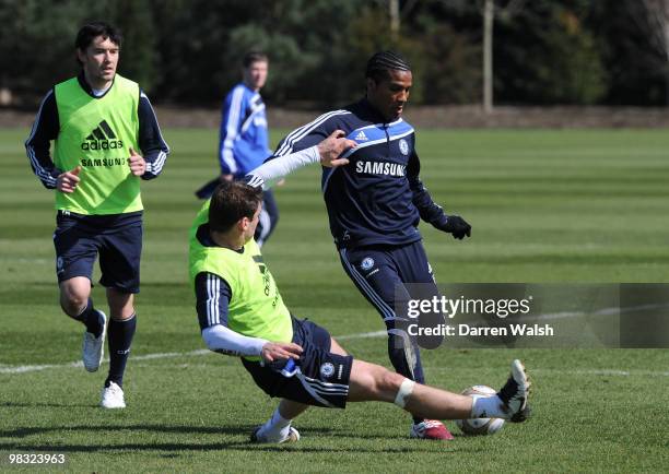 Florent Malouda and Branislav Ivanovic of Chelsea in action during a training session at the Cobham training ground on April 8, 2010 in Cobham,...