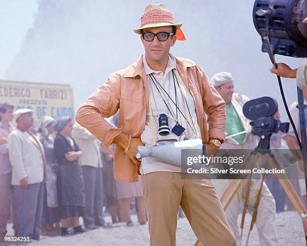 English actor Peter Sellers plays a conman playing a movie director in 'Caccia alla Volpe' , 1966.