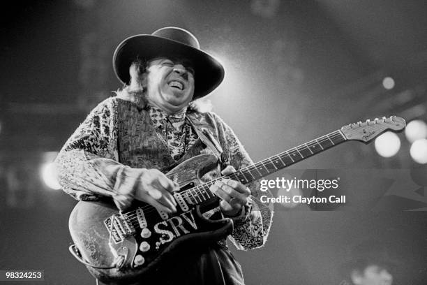 Stevie Ray Vaughan performing at the Oakland Coliseum Arena on December 3, 1989. He plays a Fender Stratocaster guitar.