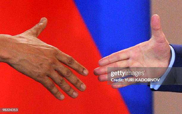 President Barack Obama shakes hands with his Russian counterpart Dmitry Medvedev during a news conference after signing the new Strategic Arms...