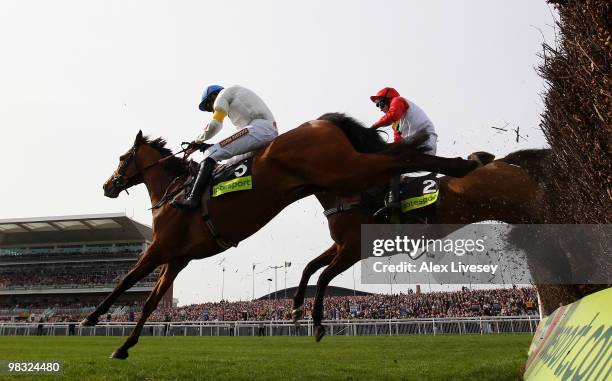 What A Friend ridden by Ruby Walsh clears the last fence ahead of Carruthers ridden by Mattie Batchelor to win The totesport Bowl Steeple Chase at...