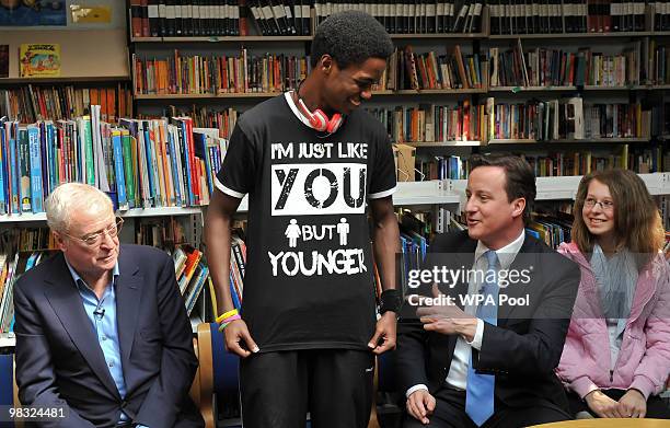 British actor Sir Michael Caine and British Opposition Conservative Party leader David Cameron look on as student Daryl Brown shows off his printed...