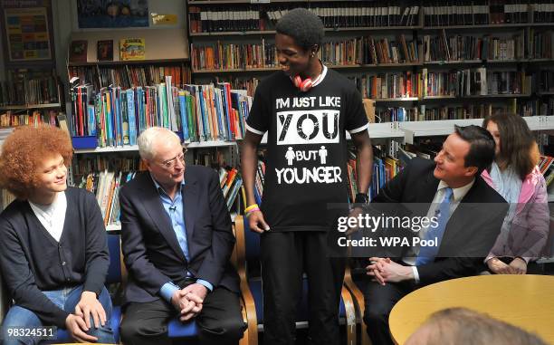 British actor Sir Michael Caine and British Opposition Conservative Party leader David Cameron look on as student Daryl Brown shows off his printed...