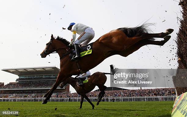 What A Friend ridden by Ruby Walsh clears a fence alongside Imperial Commander ridden by Paddy Brennan on their way to victory in The totesport Bowl...