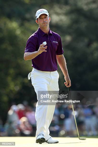 Mike Weir of Canada holds up his ball after putting on the first hole during the first round of the 2010 Masters Tournament at Augusta National Golf...