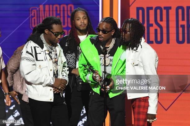 Hip hop trio Migos accepts the award for Best Group during the BET Awards at Microsoft Theatre in Los Angeles, California, on June 24, 2018.