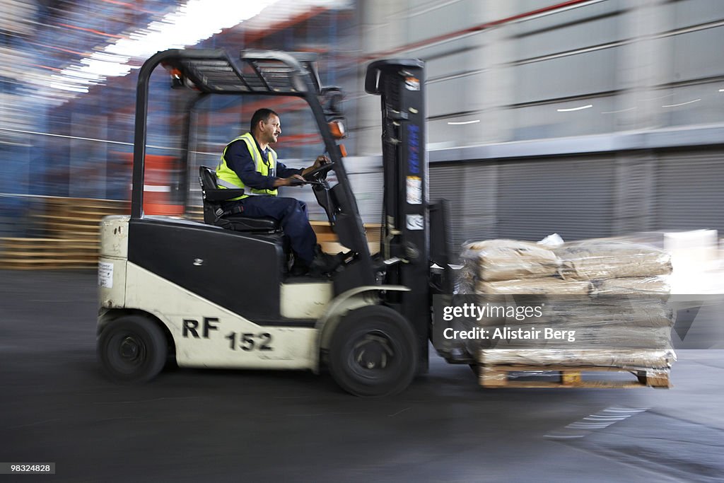 Blurred motion view of forklift truck