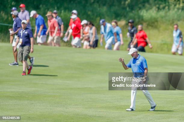 Jerry Kelly waves to the crowd on eighteen during the final round of the American Family Insurance Championship Champions Tour golf tournament on...