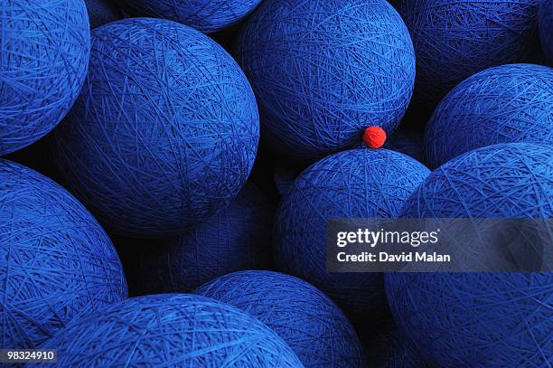 large blue woolen balls with one small red one. - small stock pictures, royalty-free photos & images