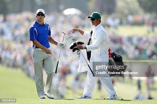 Paul Casey of England hands a club off to his caddie Christian Donald during the first round of the 2010 Masters Tournament at Augusta National Golf...