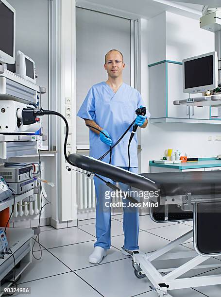 male doctor holding endoscope, portrait - endoscope stock pictures, royalty-free photos & images