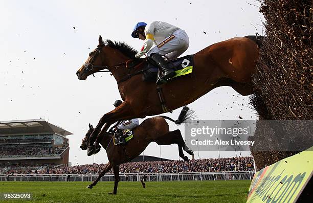 What A Friend ridden by Ruby Walsh clears a fence alongside Imperial Commander ridden by Paddy Brennan on their way to victory in The totesport Bowl...