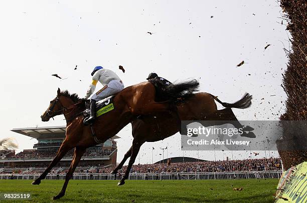 What A Friend ridden by Ruby Walsh clears a fence alongside Imperial Commander ridden by Paddy Brennan on their way to victory in The totesport Bowl...