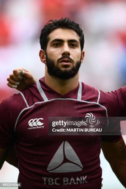 Georgia's centre Giorgi Kveseladze listens to the anthems prior the rugby union Test match between Japan and Georgia at Toyota Stadium in Toyota on...