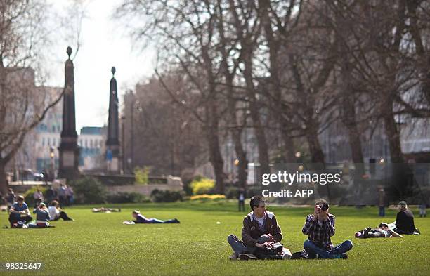 People enjoy the sunshine in Victoria Tower Gardens in central London, on April 8, 2010. Britain is expected to get a dose of spring sunshine this...